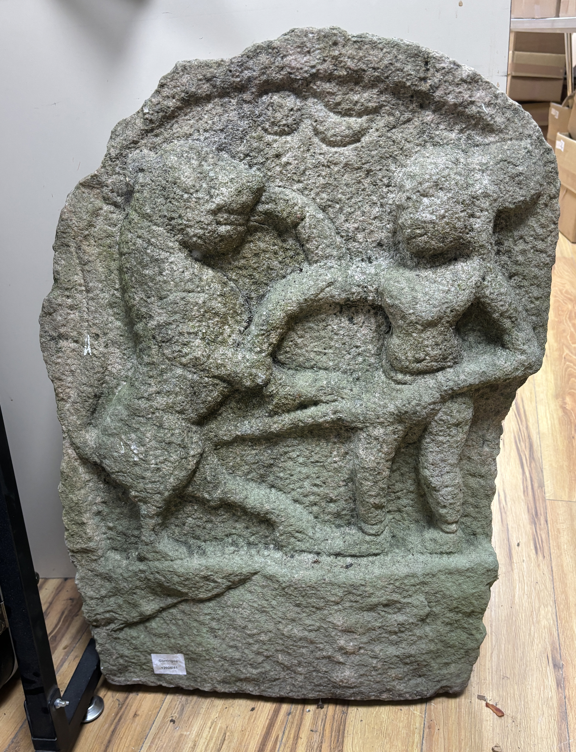 A large Indian stone relief, depicting a figure fighting a leopard or tiger, 75cm